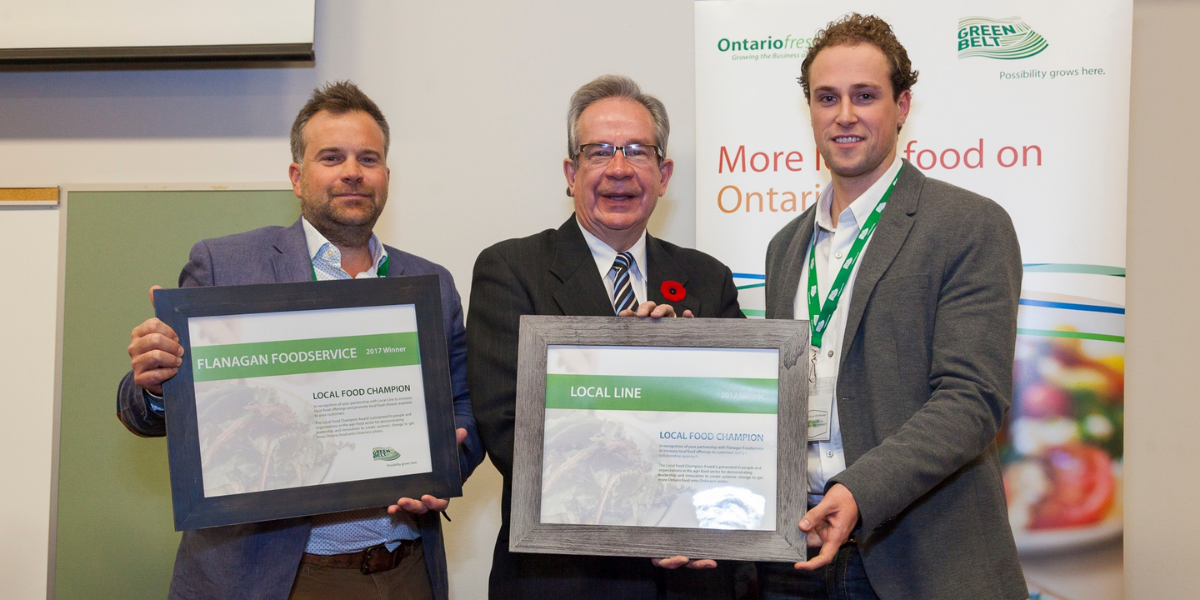 Pete Bozzer (Director of Procurement, Flanagan Foodservice) and Cole Jones (Founder, Local Line) being presented with their Local Food Champion Awards by Jeff Leal, Ontario Minister of Agriculture, Food and Rural Affairs
